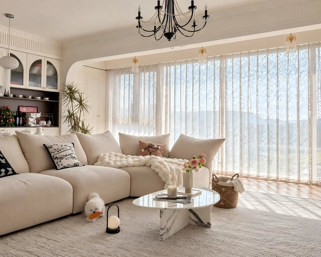 Elegant white sheer curtains in a bright, neutral-toned living room with a cream sofa and natural daylight.